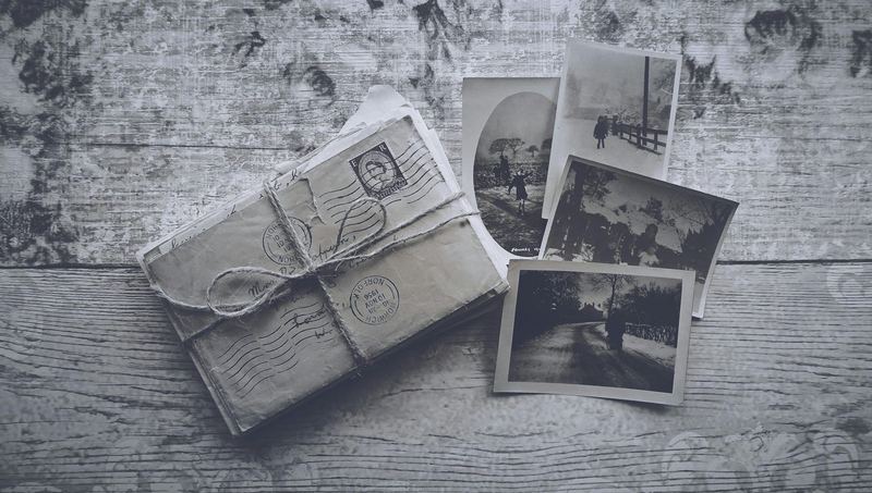 A bundle of envelopes and old photographs tied with string