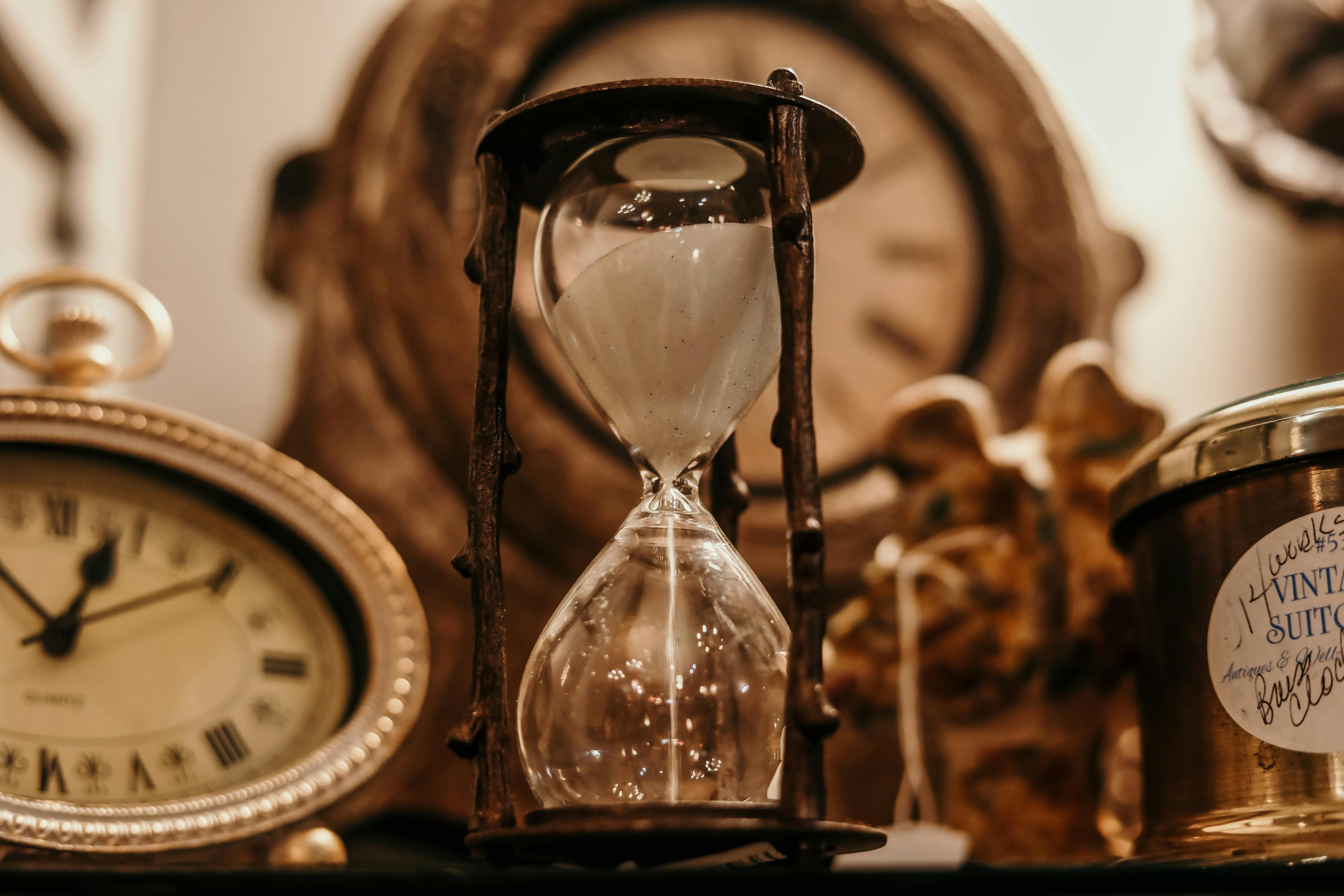 An hourglass and vintage clock representing the passage of time